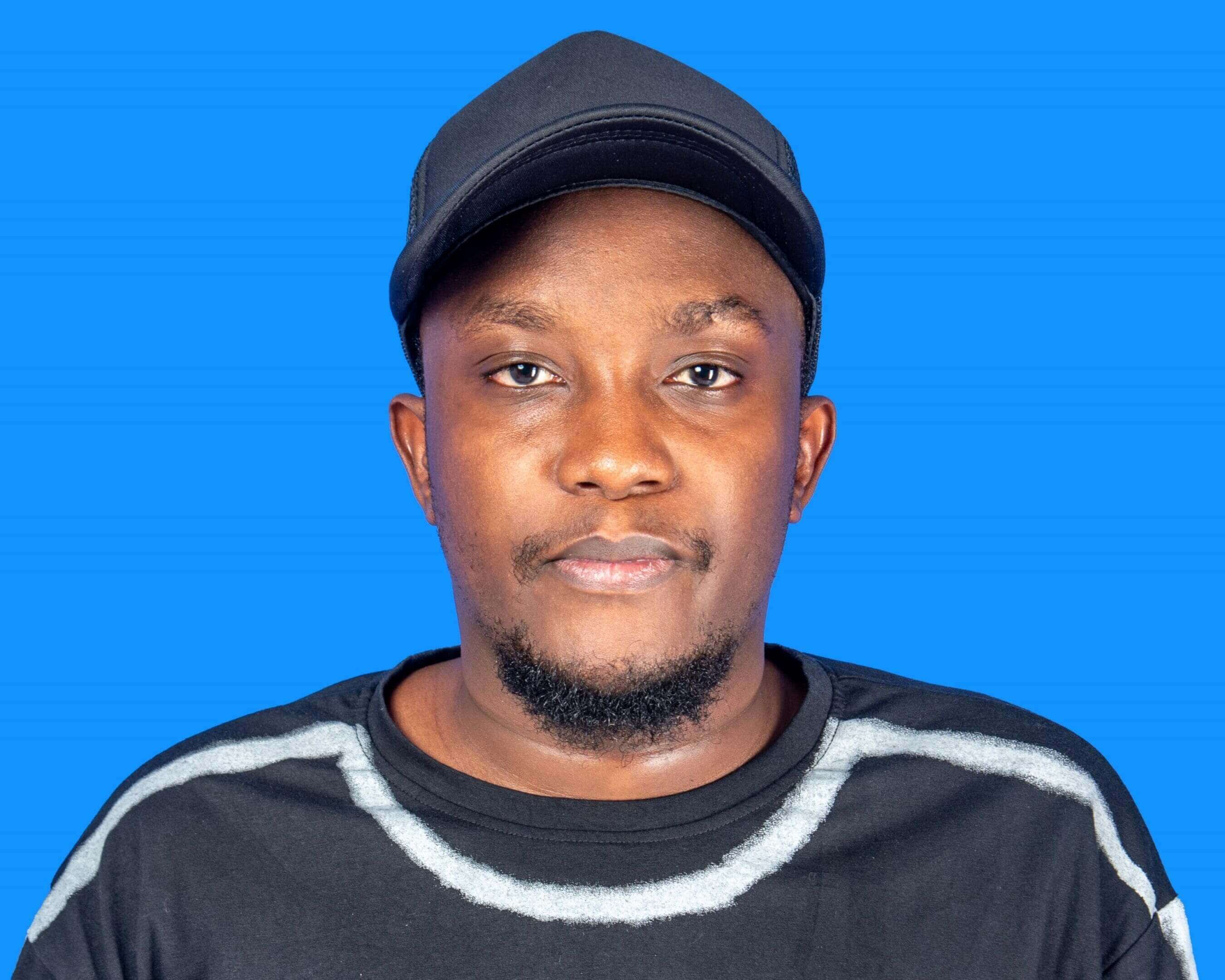 A man wearing a black hat and a black shirt.